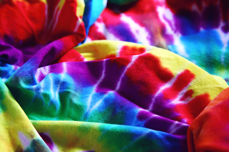 Photo showing brightly colored tie dye fabrics