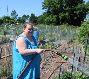 Lindsey tends to community garden 